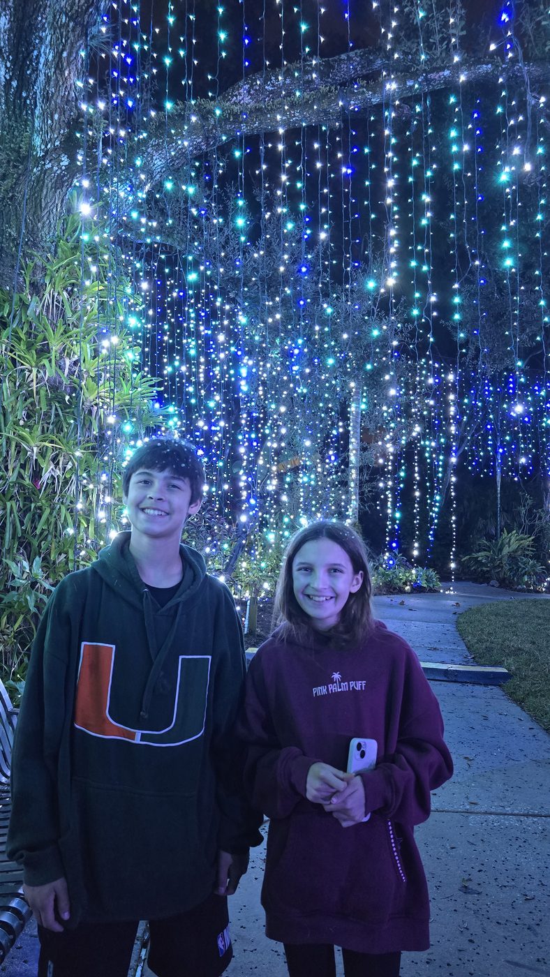 Lexi and Ryan under Christmas lights
